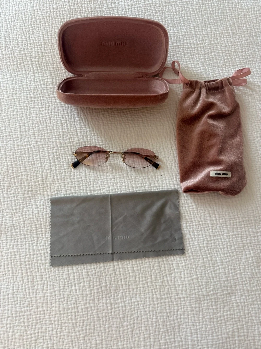Miu Miu Oval Sunglasses